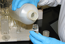 pouring a sample from a bottle to tube