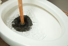 plunger-working-on-toilet-clog-royalty-free-image-185122993-1540318418